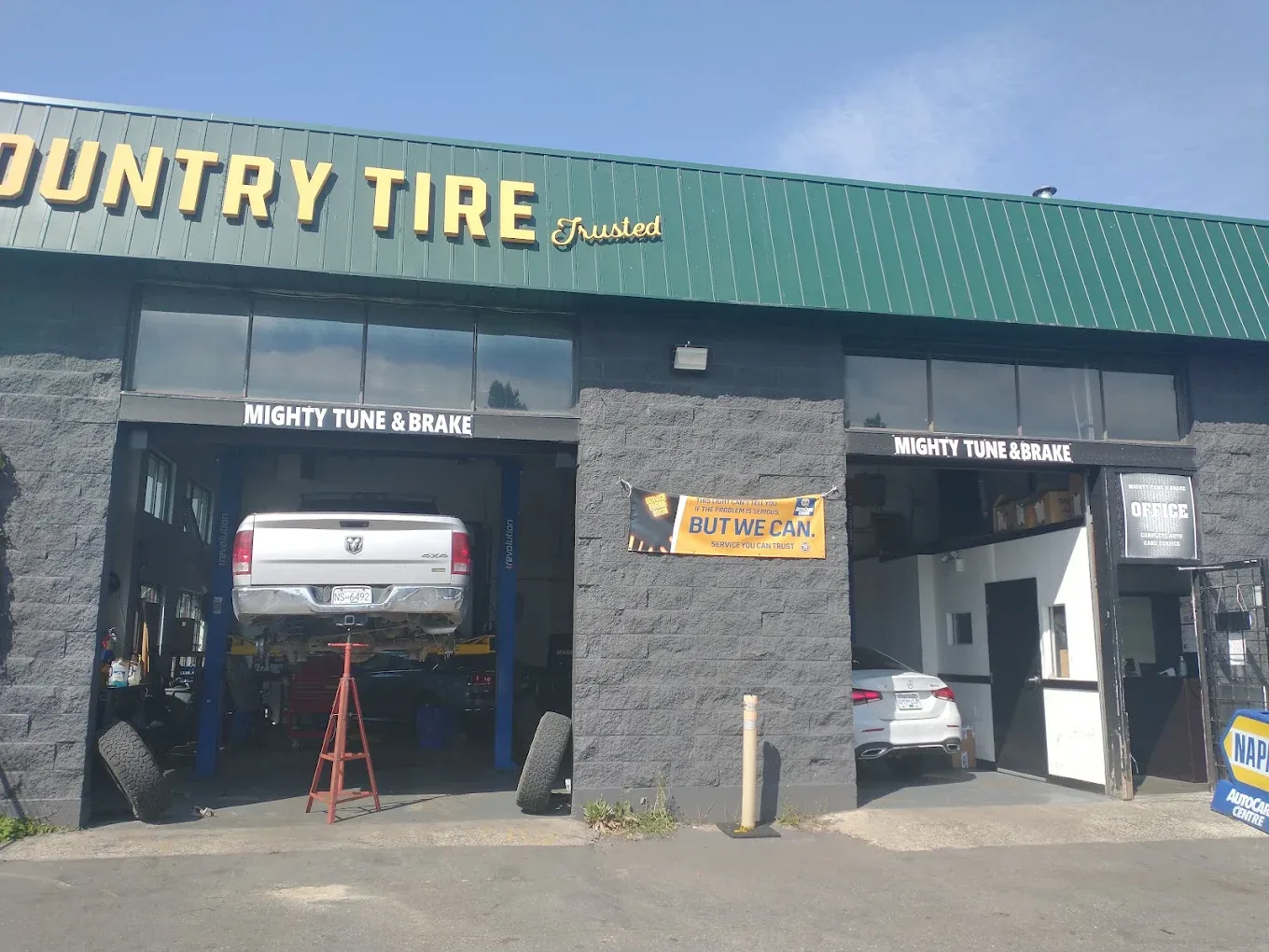 A Mainland Lube service bay with a vehicle on the hoist